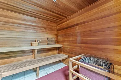 a sauna with wooden walls and benches in a cabin at Tropic Winds 703 in Panama City Beach