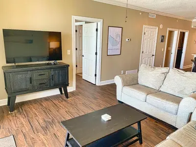 a living room with a couch and a table at Ocean Reef 1308 in Panama City Beach
