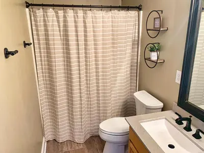a bathroom with a shower curtain and a toilet at Ocean Reef 1308 in Panama City Beach