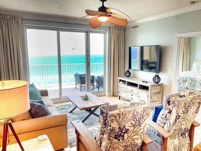 a living room with a view of the ocean at Ocean Reef 1604 in Panama City Beach