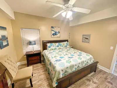 a bedroom with a bed and a ceiling fan at Ocean Reef 1401 in Panama City Beach