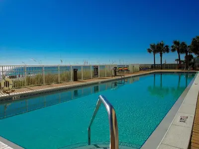 a large blue swimming pool next to the beach at Ocean Reef 1401 in Panama City Beach