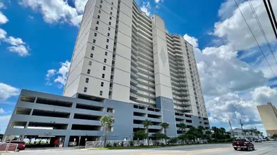 a tall white building on a city street at Ocean Reef 1402 in Panama City Beach