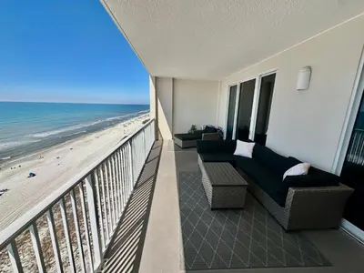 a balcony with a couch and a view of the beach at Ocean Reef 1107 in Panama City Beach