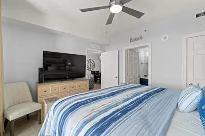 a bedroom with a bed and a flat screen tv at Tropic Winds 1903 in Panama City Beach