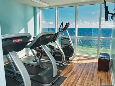 a gym with two exercise bikes in front of a window at Tropic Winds 1903 in Panama City Beach