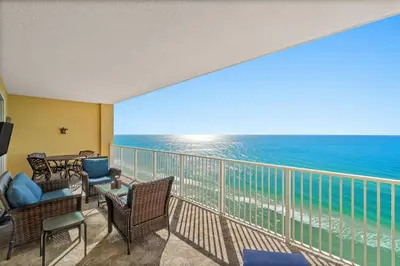 a balcony with chairs and a view of the ocean at Tropic Winds 1903 in Panama City Beach