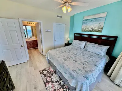 a bedroom with a bed and a ceiling fan at Ocean Reef 1007 in Panama City Beach
