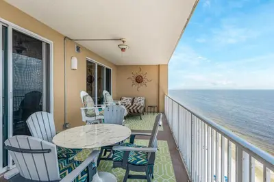 a balcony with a table and chairs and the ocean at Tropic Winds 1909 in Panama City Beach