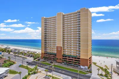 a tall building next to the beach and the ocean at Tropic Winds 1605 in Panama City Beach