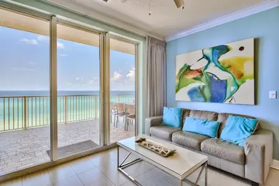 a living room with a couch and a view of the ocean at Tropic Winds 707 in Panama City Beach