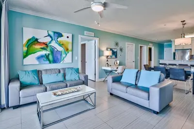 a living room with a couch and a table at Tropic Winds 707 in Panama City Beach