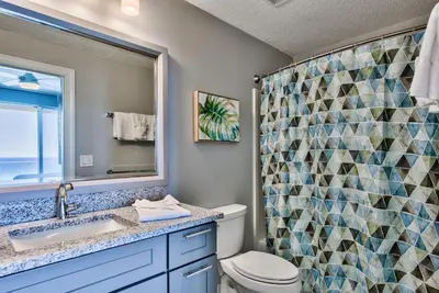 a bathroom with a toilet and a sink and a shower at Tropic Winds 603 in Panama City Beach