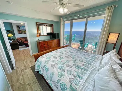 a bedroom with a bed and a view of the ocean at Ocean Reef 1808 in Panama City Beach