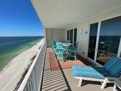 a balcony with chairs and a table and the ocean at Ocean Reef 1808 in Panama City Beach