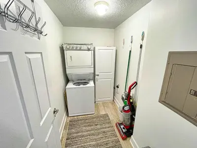 a small kitchen with a refrigerator and a stove at Ocean Reef 1808 in Panama City Beach