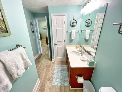 a bathroom with a sink and a mirror at Ocean Reef 1808 in Panama City Beach