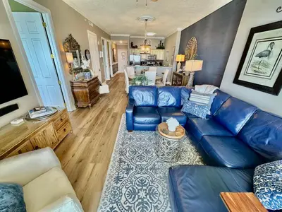 a living room with a blue leather couch at Ocean Reef 2308 in Panama City Beach