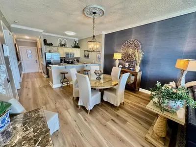 a dining room and kitchen with a table and chairs at Ocean Reef 2308 in Panama City Beach