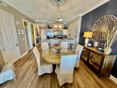 a kitchen and dining room with a table and chairs at Ocean Reef 2308 in Panama City Beach