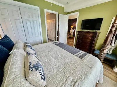 a bedroom with a bed and a flat screen tv at Ocean Reef 2308 in Panama City Beach