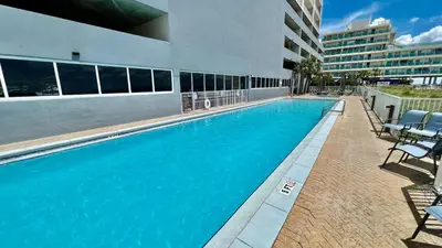 a large blue swimming pool in a building at Ocean Reef 2308 in Panama City Beach