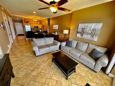 a living room with two couches and a table at Ocean Reef 1902 in Panama City Beach