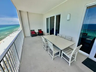 a balcony with a table and chairs and the ocean at Ocean Reef 1902 in Panama City Beach