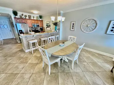 a kitchen and dining room with a table and chairs at Ocean Reef 802 in Panama City Beach
