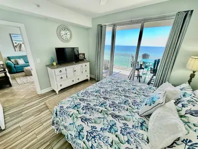 a bedroom with a bed and a view of the ocean at Ocean Reef 802 in Panama City Beach