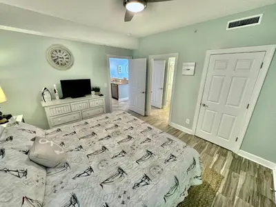 a bedroom with a large bed and a television at Ocean Reef 802 in Panama City Beach