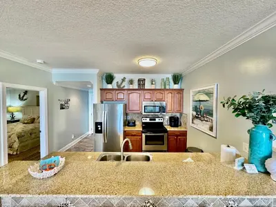 a kitchen with a sink and a counter top at Ocean Reef 802 in Panama City Beach