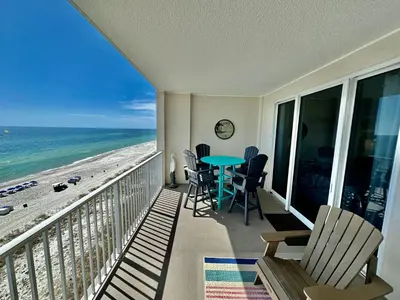 a balcony with a table and chairs and the beach at Ocean Reef 802 in Panama City Beach