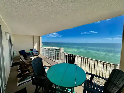 a balcony with a table and chairs and the ocean at Ocean Reef 802 in Panama City Beach