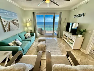 a living room with a blue couch and a television at Ocean Reef 802 in Panama City Beach