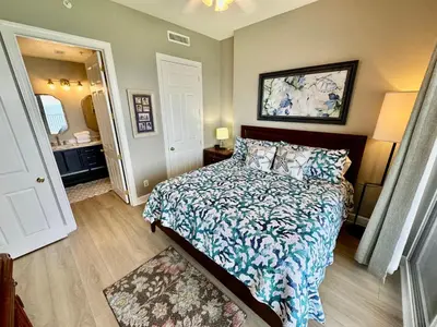 a bedroom with a bed with a blue and white comforter at Ocean Reef 1907 in Panama City Beach