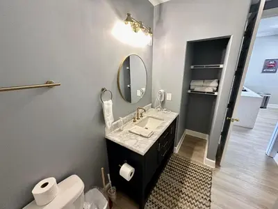 a bathroom with a sink and a mirror and a toilet at Ocean Reef 1907 in Panama City Beach