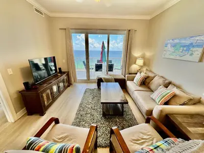 a living room with a couch and a tv at Ocean Reef 1907 in Panama City Beach