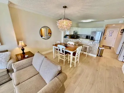 a living room with a couch and a table at Tropic Winds 1107 in Panama City Beach
