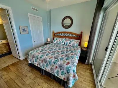 a bedroom with a bed and a mirror on the wall at Ocean Reef 2103 in Panama City Beach