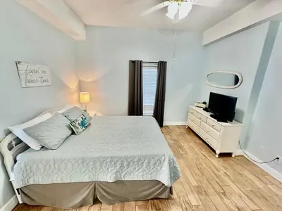 a bedroom with a bed and a tv on a dresser at Ocean Reef 2103 in Panama City Beach