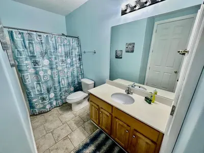 a bathroom with a sink and a toilet and a shower at Ocean Reef 2103 in Panama City Beach