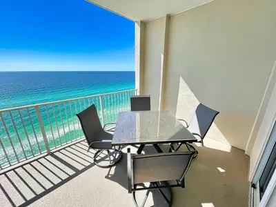 a table and chairs on a balcony with the ocean at Ocean Reef 2103 in Panama City Beach