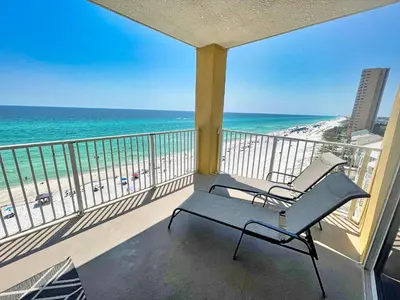 a balcony with a chair and the beach at Tropic Winds 809 in Panama City Beach