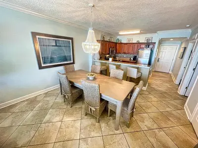 a kitchen and dining room with a table and chairs at Tropic Winds 809 in Panama City Beach
