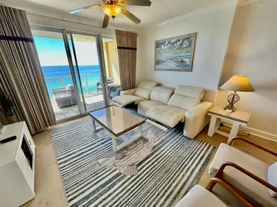 a living room with a couch and a view of the ocean at Tropic Winds 1201 in Panama City Beach