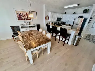 a kitchen and dining room with a table and chairs at Tropic Winds 1201 in Panama City Beach