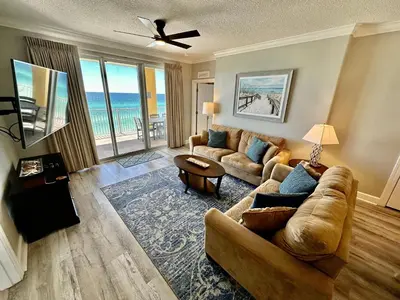 a living room with a couch and a table at Tropic Winds 605 in Panama City Beach