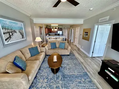 a living room with a couch and a table at Tropic Winds 605 in Panama City Beach