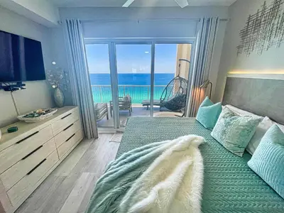 a bedroom with a bed with a view of the ocean at Ocean Reef 2204 in Panama City Beach